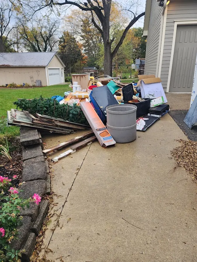 Dumpster being loaded with debris for Roofing Dumpster Rental in Redland